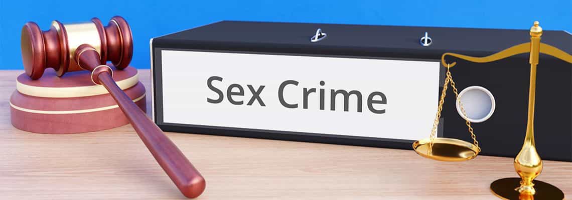 A folder that states "Sex Crime" next to a gavel and libra scale.
